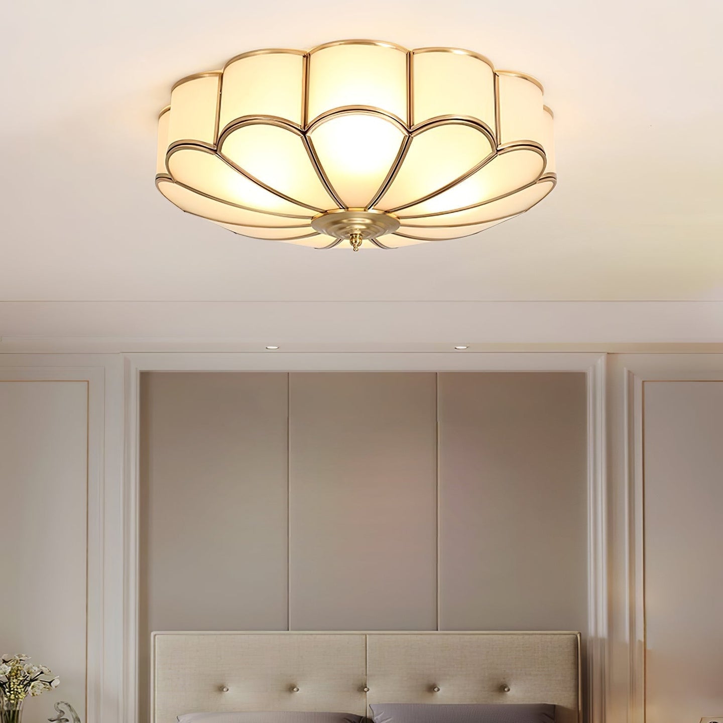 Ulina petal ceiling light lit above a bed in a panelled bedroom