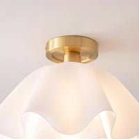 Close view of the brass canopy and the layered acrylic petals of the Ondra ceiling light