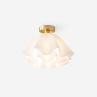 Ondra ruffled white petal semi flush ceiling light with brass canopy on a plain white background