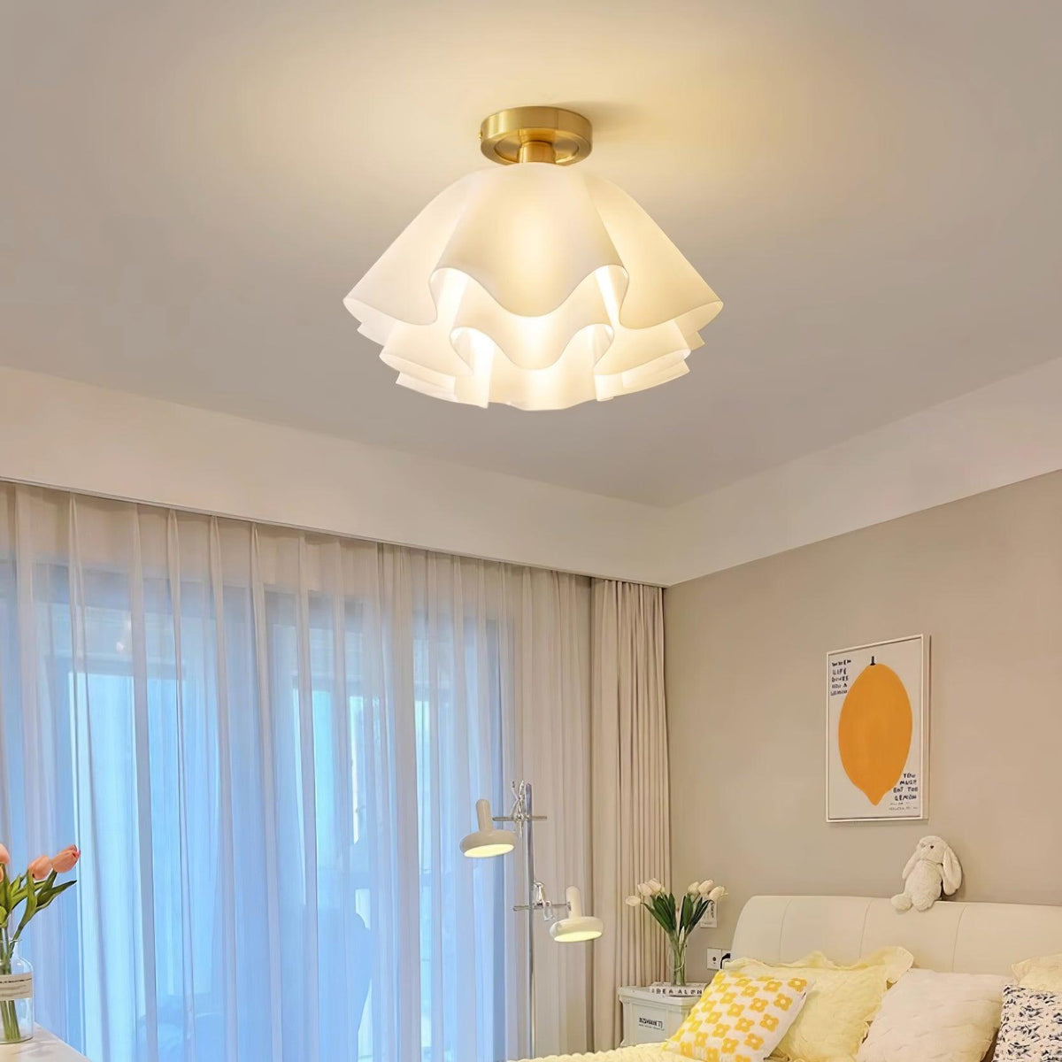 Ondra petal ceiling light fitted in a bedroom with sheer curtains and a soft yellow scheme