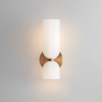 Solia Twin Glass Wall Sconce on a plain background showing the opal glass cylinder, brass bracket and lower glass cup