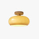 Charo Wood Cap Glass Ceiling Light on a plain white background showing the amber glass dome and wood cap