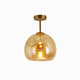 Belvo amber glass dome semi flush ceiling light with brass rod on a plain white background