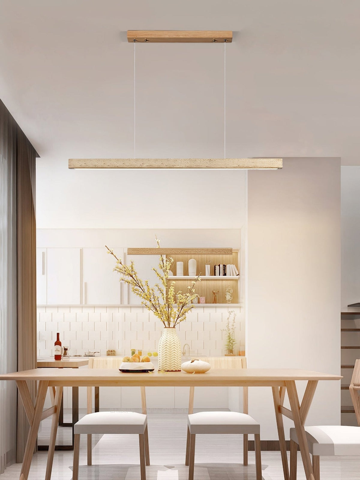 Sonvel travertine linear pendant lighting a dining table in a modern kitchen
