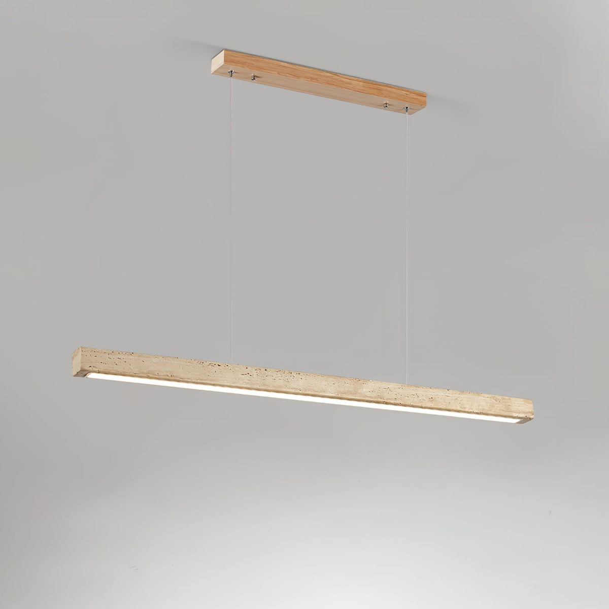 Angled view of the Sonvel travertine bar pendant lit, showing the LED diffuser along the underside