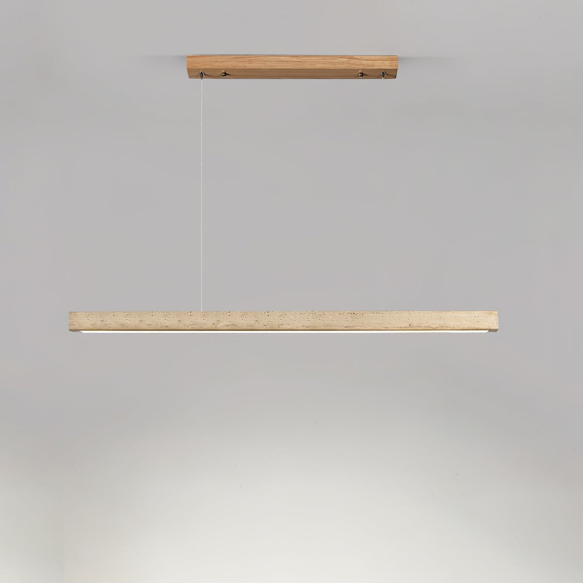 Sonvel travertine pendant with light wood ceiling canopy and suspension cables against a plain grey wall