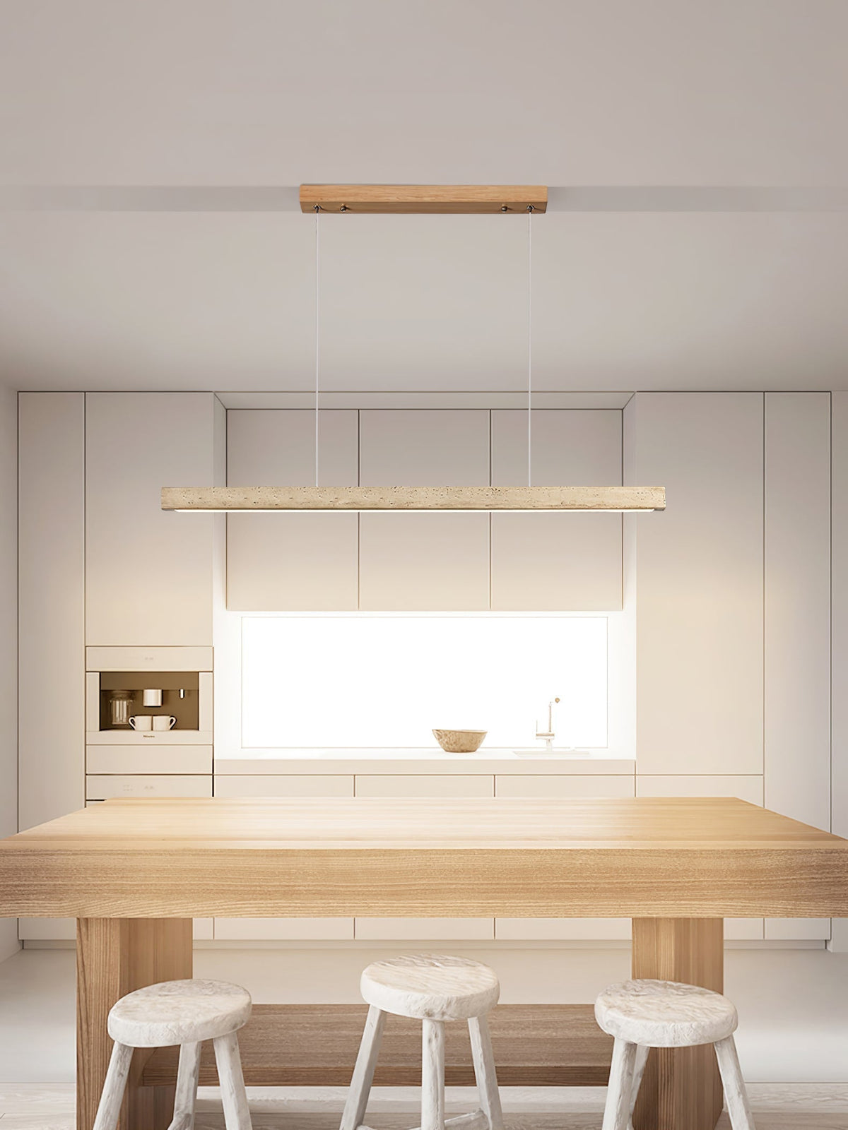 Sonvel linear pendant hanging over a pale wood kitchen island
