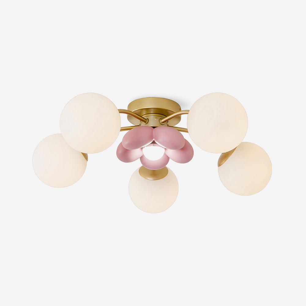 Peona five light flush mount ceiling light seen from the side, gold arms and opal white glass globes