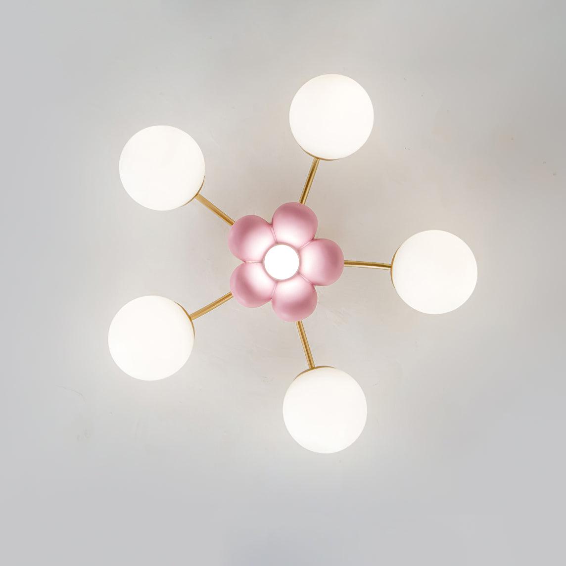 Peona ceiling light viewed from directly below showing the five petal flower centre and five radiating gold arms