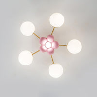 Peona ceiling light viewed from directly below showing the five petal flower centre and five radiating gold arms