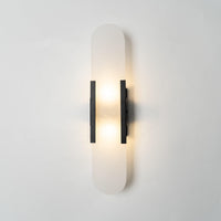 Veola alabaster wall light lit, showing warm light glowing through the natural stone