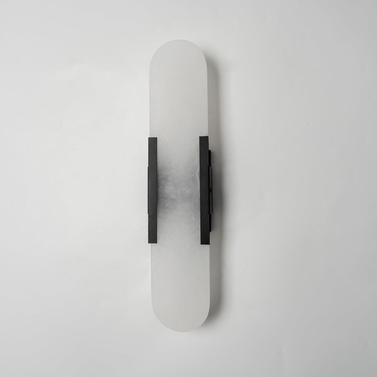 Lockhone Veola alabaster wall light with black metal bars, unlit, on a plain pale wall