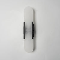 Lockhone Veola alabaster wall light with black metal bars, unlit, on a plain pale wall