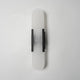 Lockhone Veola alabaster wall light with black metal bars, unlit, on a plain pale wall