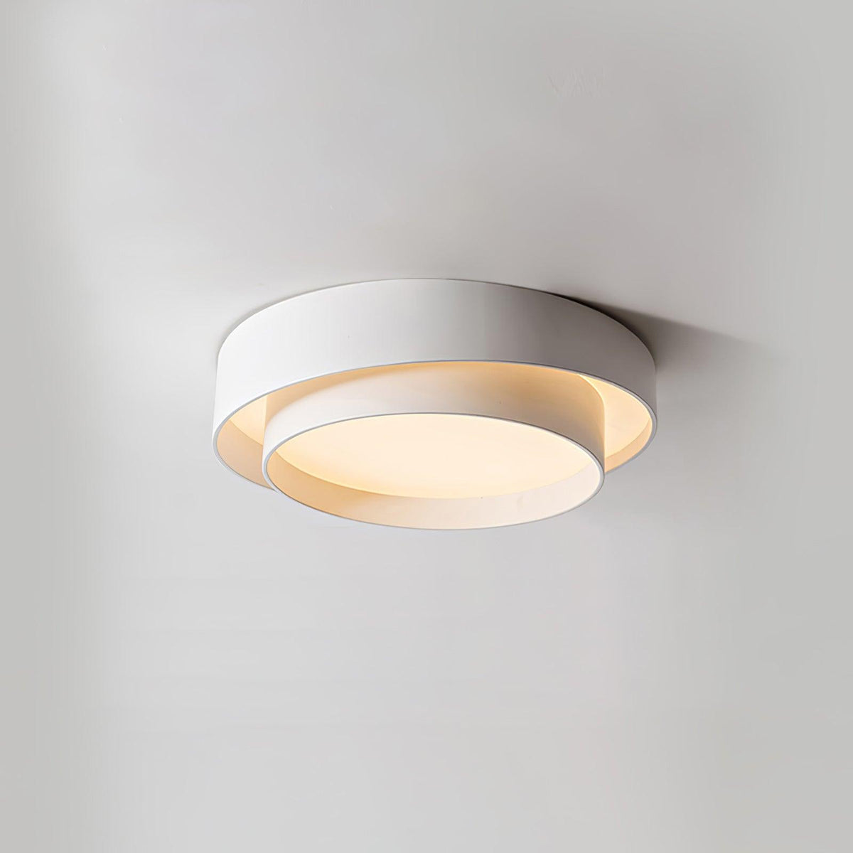 Belna white ceiling light mounted flush against a plain ceiling and lit warm
