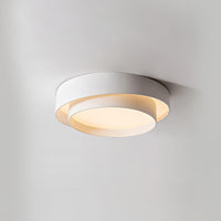 Belna white ceiling light mounted flush against a plain ceiling and lit warm