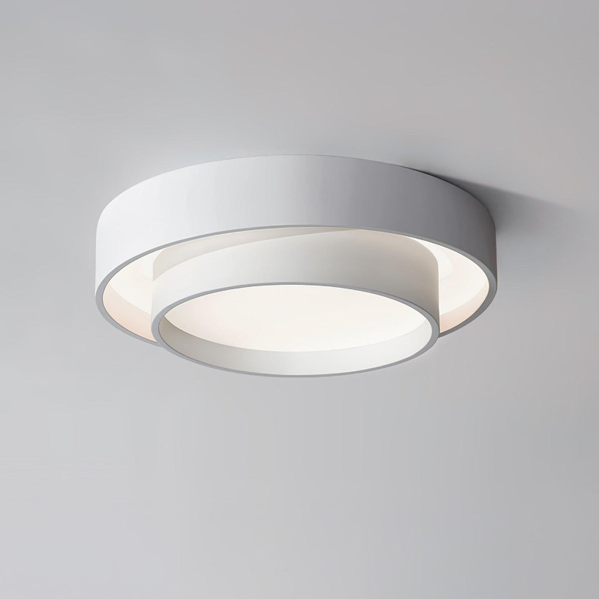 Angled view of the Belna white stepped drum ceiling light against a pale ceiling
