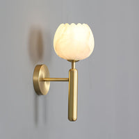 Pellora alabaster wall sconce mounted on a soft grey wall, brushed brass arm and backplate
