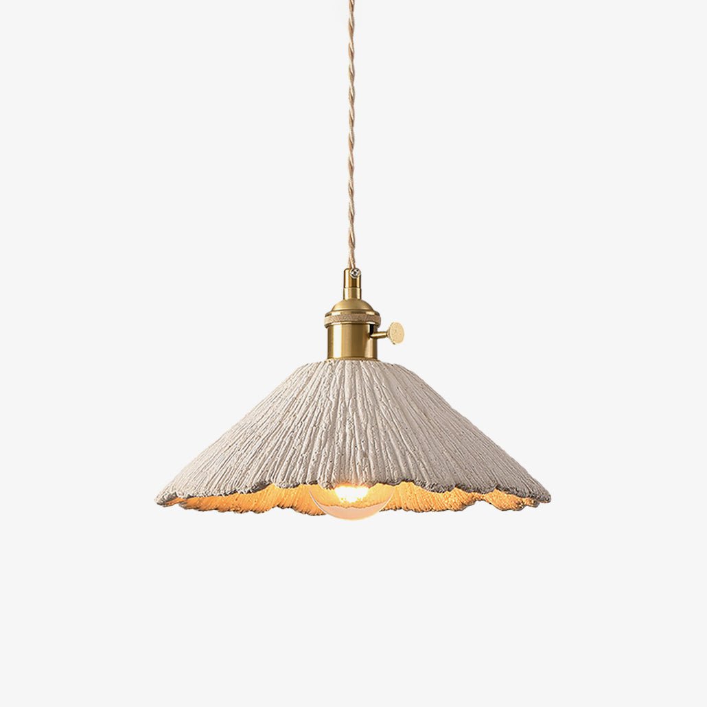 Plavo scalloped cement pendant light with brass holder on a plain pale background