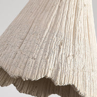 Detail of the ribbed microcement surface and torn scalloped rim of the Plavo shade