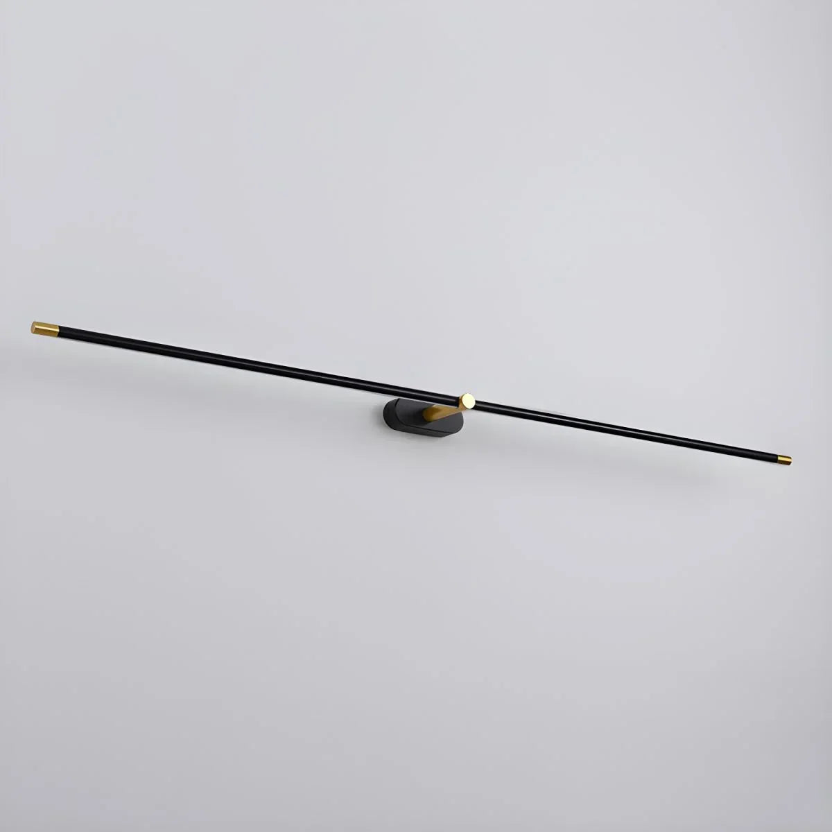 Ivo slim black and gold LED wall light shown at an angle against a pale grey wall