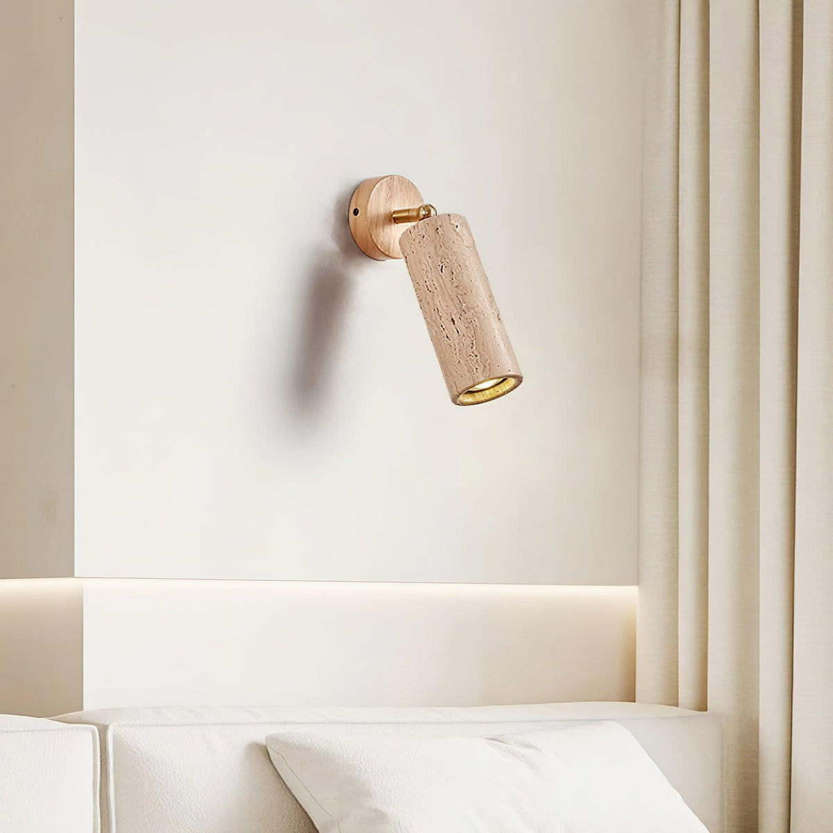 Sintra travertine wall light fitted above a bed as a bedside reading light