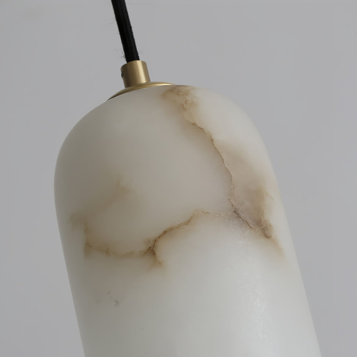 Close view of the Uvella alabaster shade showing the natural veining in the stone