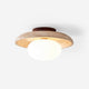 Renvo travertine disc flush ceiling light with opal glass dome on a plain white background