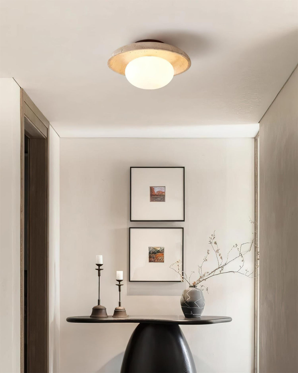 Renvo flush ceiling light lit above a hallway console table