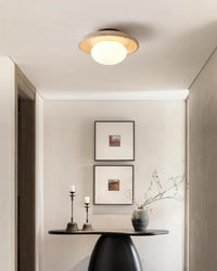 Renvo flush ceiling light lit above a hallway console table