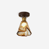 Orva Amber Glass Semi-Flush Light on plain background, lit, walnut canopy and brass collar