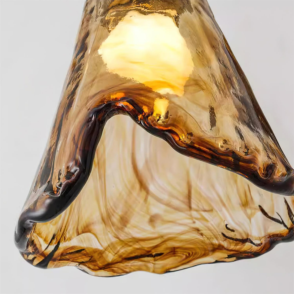 Orva Amber Glass Semi-Flush Light - extreme close-up of amber marbled glass lit from inside