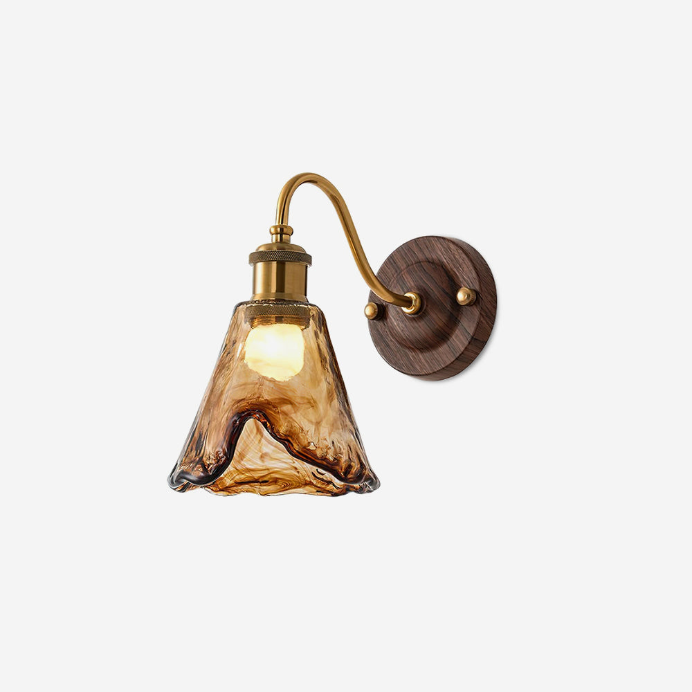Ambro amber glass wall sconce with a gold arm and walnut backplate on a plain white background