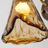 Close up of the swirled amber and brown glass shade on the Ambro wall sconce