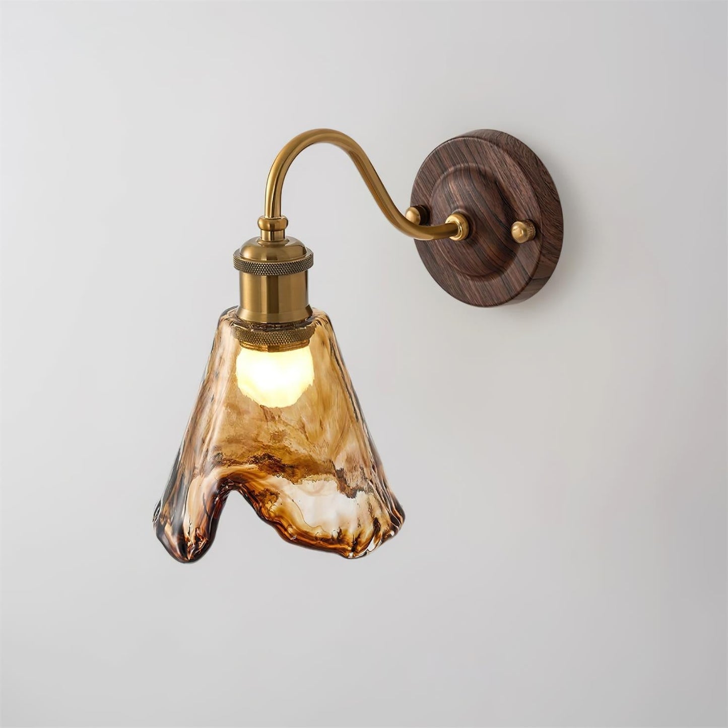 Ambro amber glass wall sconce lit, shown side on against a plain grey wall