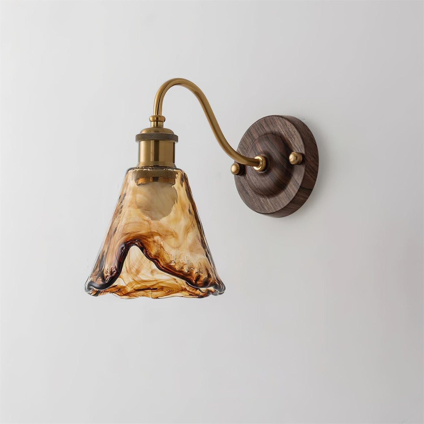 Ambro wall sconce showing the ruffled edge of the swirled amber glass shade
