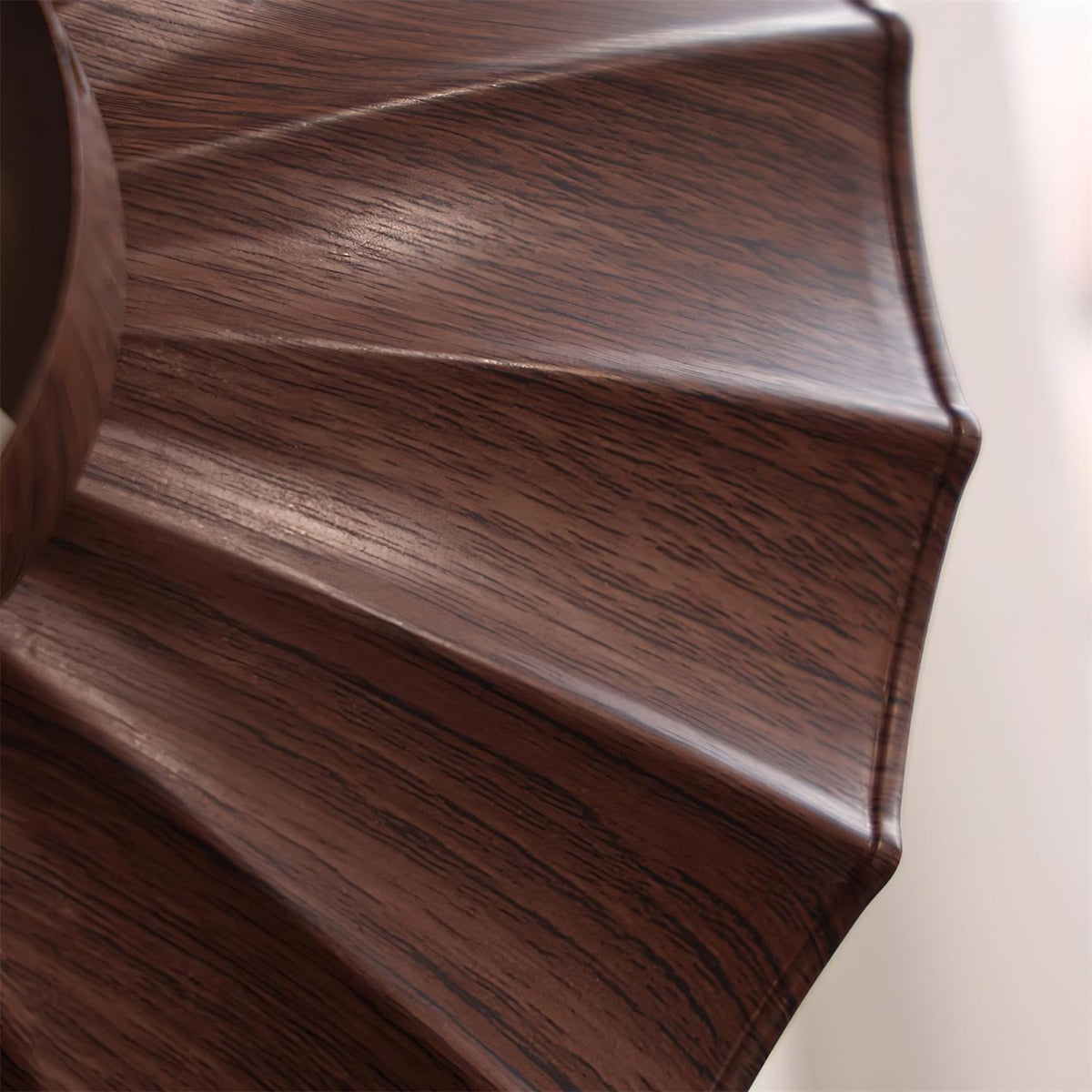 Close-up of the walnut woodgrain pleating on the Wynto ceiling light shade