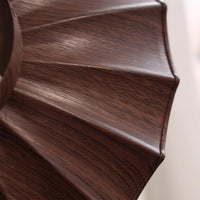 Close-up of the walnut woodgrain pleating on the Wynto ceiling light shade