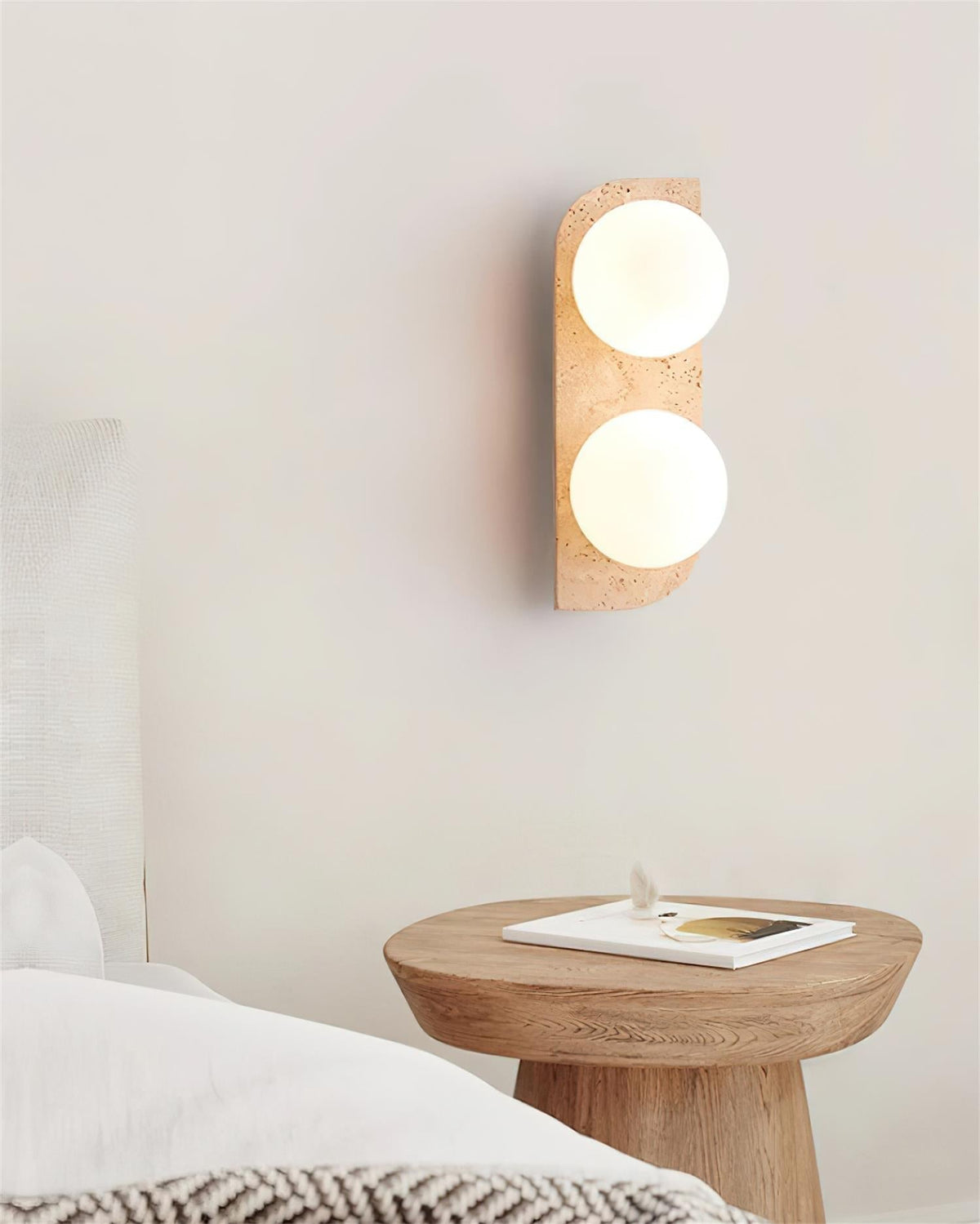 Varro Travertine Wall Lamp styled in a bedroom setting