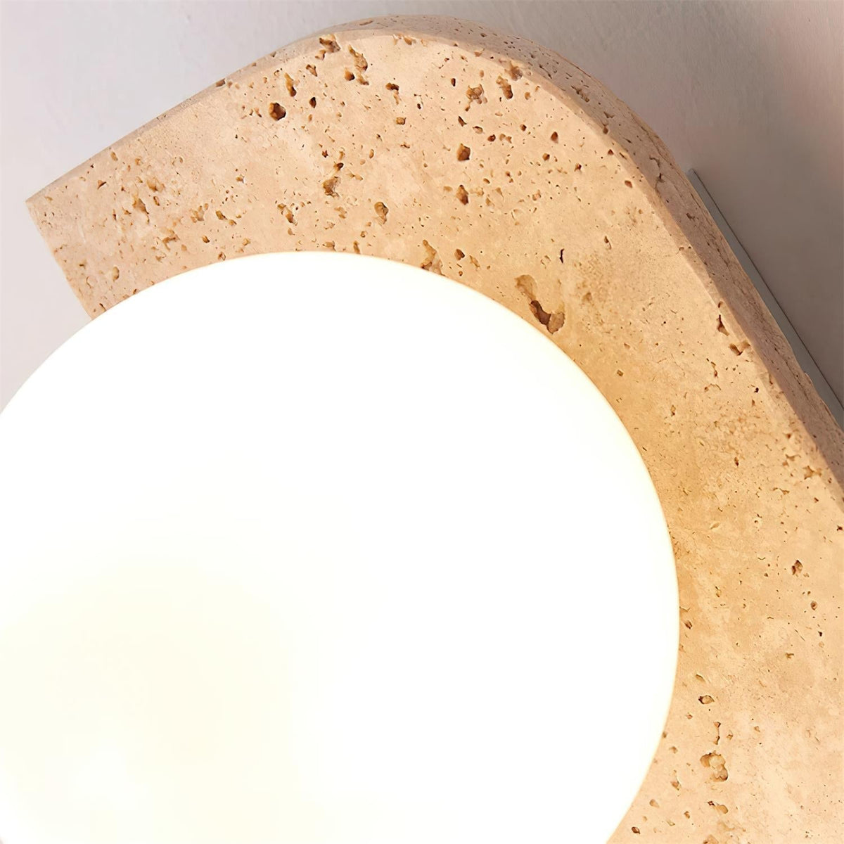 Varro Travertine Wall Lamp - close-up of travertine arch and frosted globe