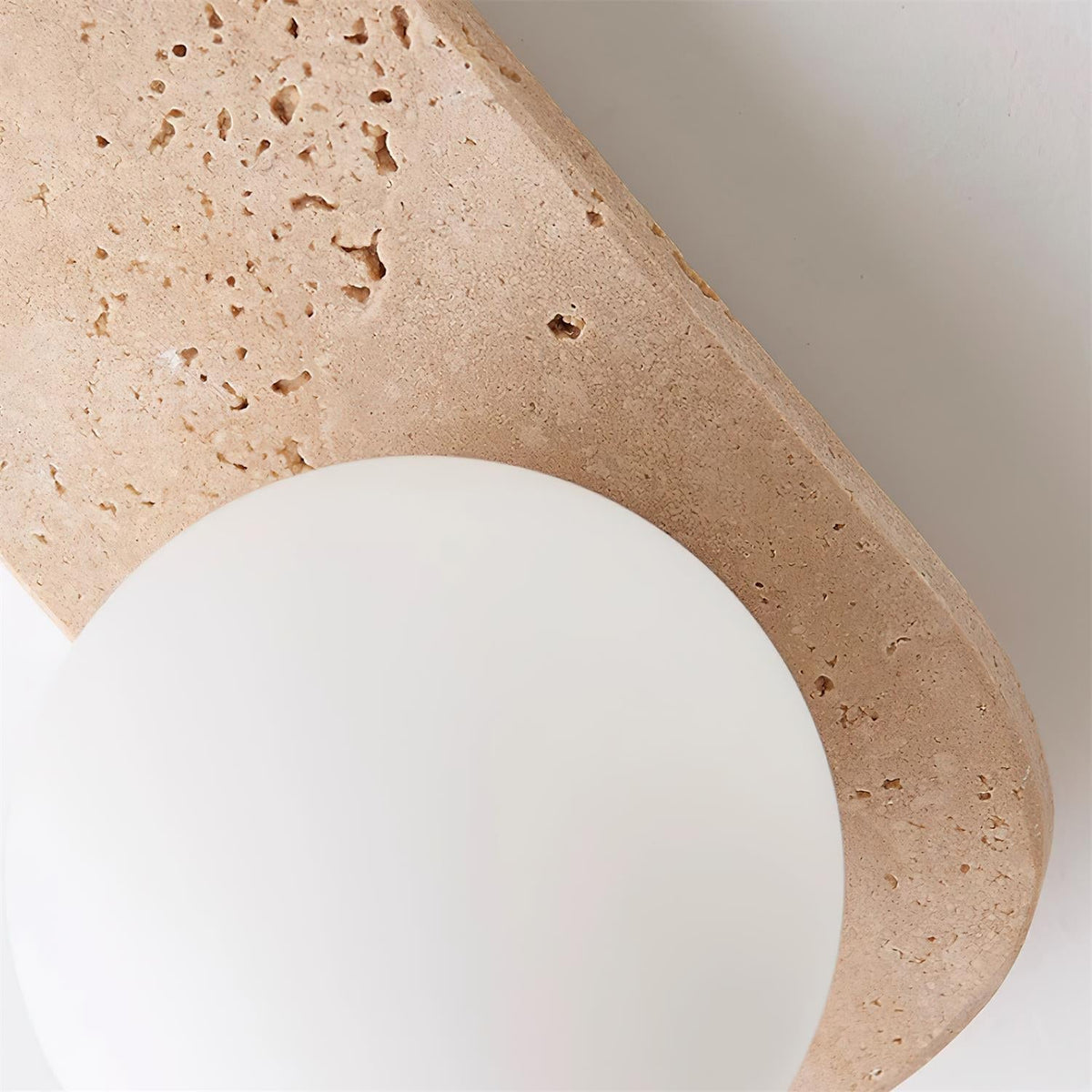 Varro Travertine Wall Lamp - travertine texture and glass globe detail