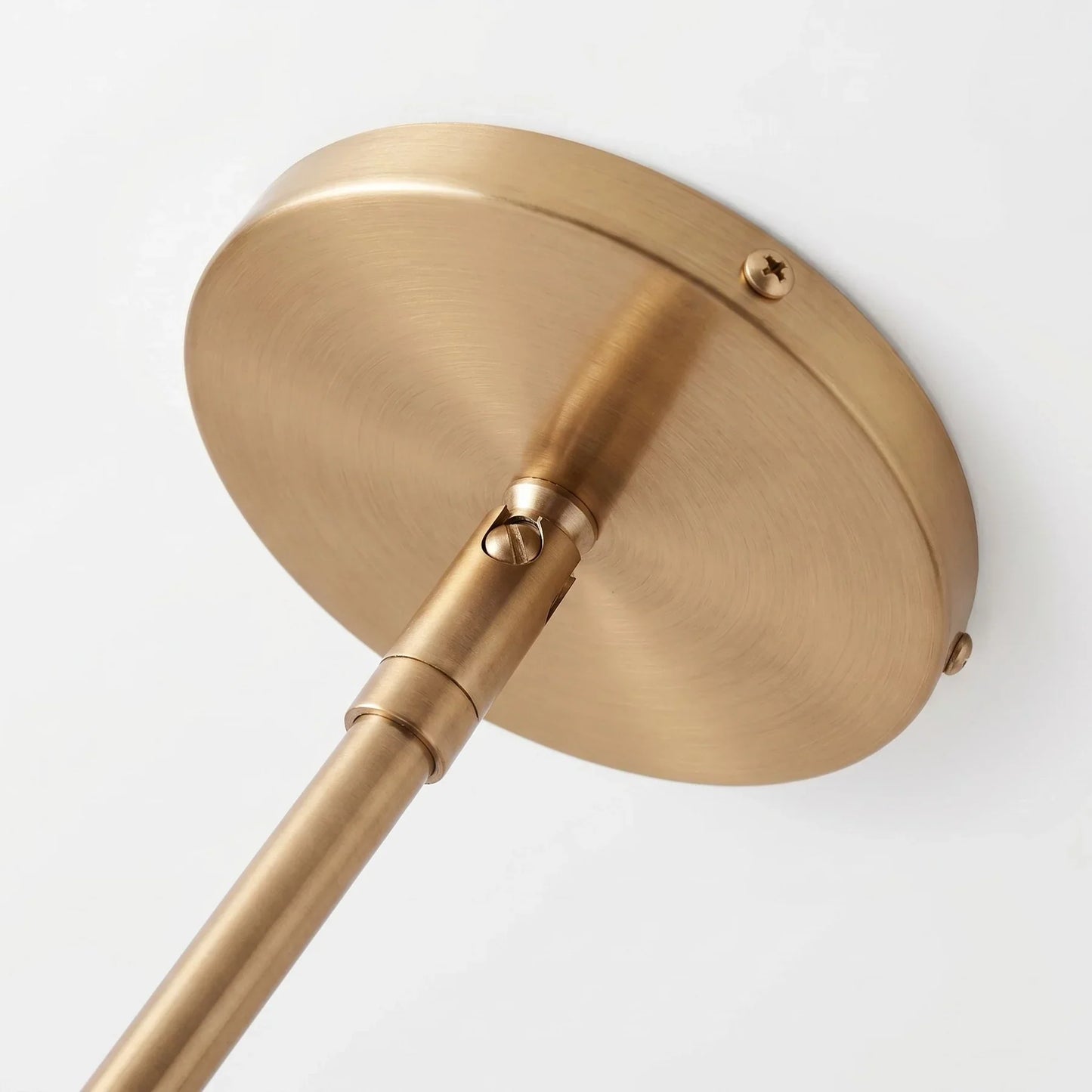 Close up of the antique brass ceiling plate and rod on the Hano pendant light