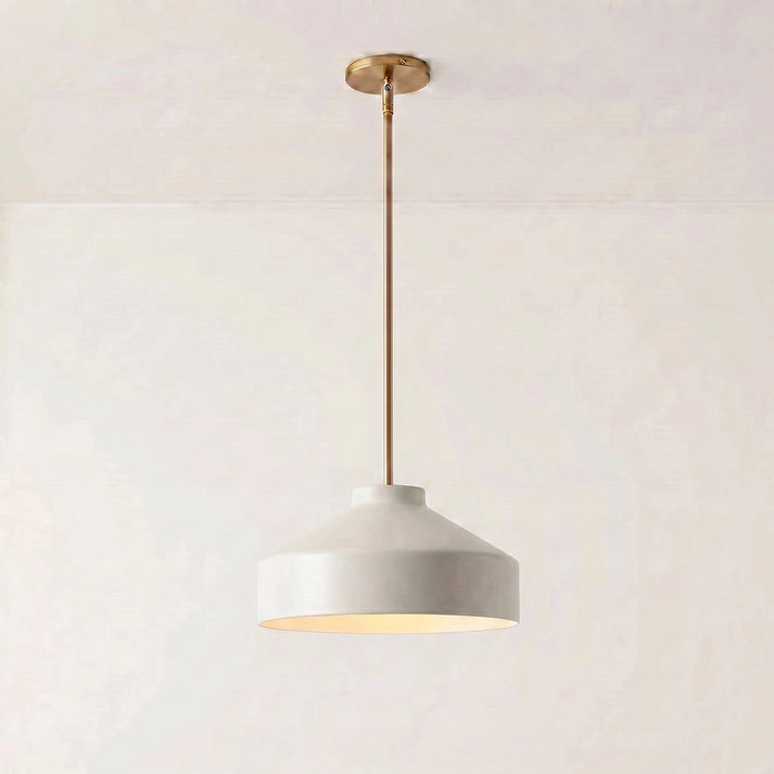 Hano ivory metal cone pendant light with antique brass rod on a plain background