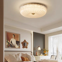 Hala fluted glass ceiling light glowing warm in a neutral bedroom