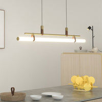 Inaro linear pendant light lit above a kitchen counter in a pale room