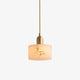 Nerva alabaster cylinder pendant light with brass fitting on a plain white background