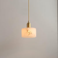Close view of the lit alabaster shade showing natural stone veining and the brass lamp holder