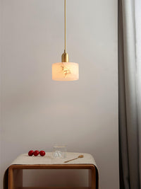Nerva alabaster pendant hanging above a small timber side table in a bedroom corner