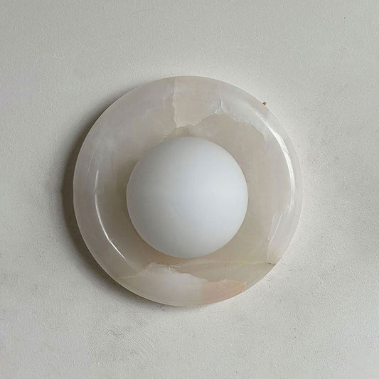 Lockhone Harko marble wall sconce in pale cream stone on a plain wall