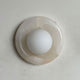 Lockhone Harko marble wall sconce in pale cream stone on a plain wall